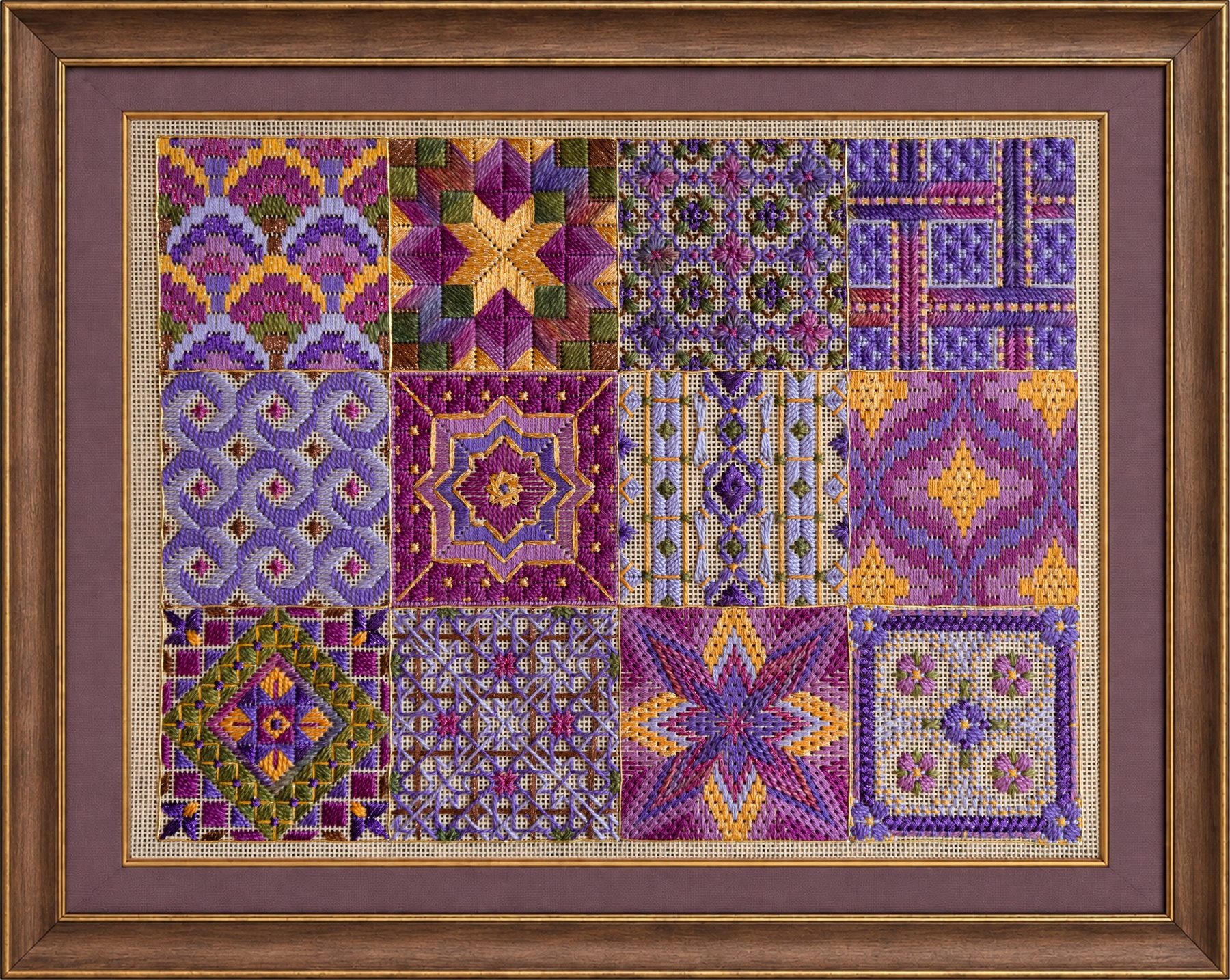 Framed finished needlepoint of The Bazaar Collection, featuring twelve colorful geometric tiles in purple, pink, gold, green, and brown.