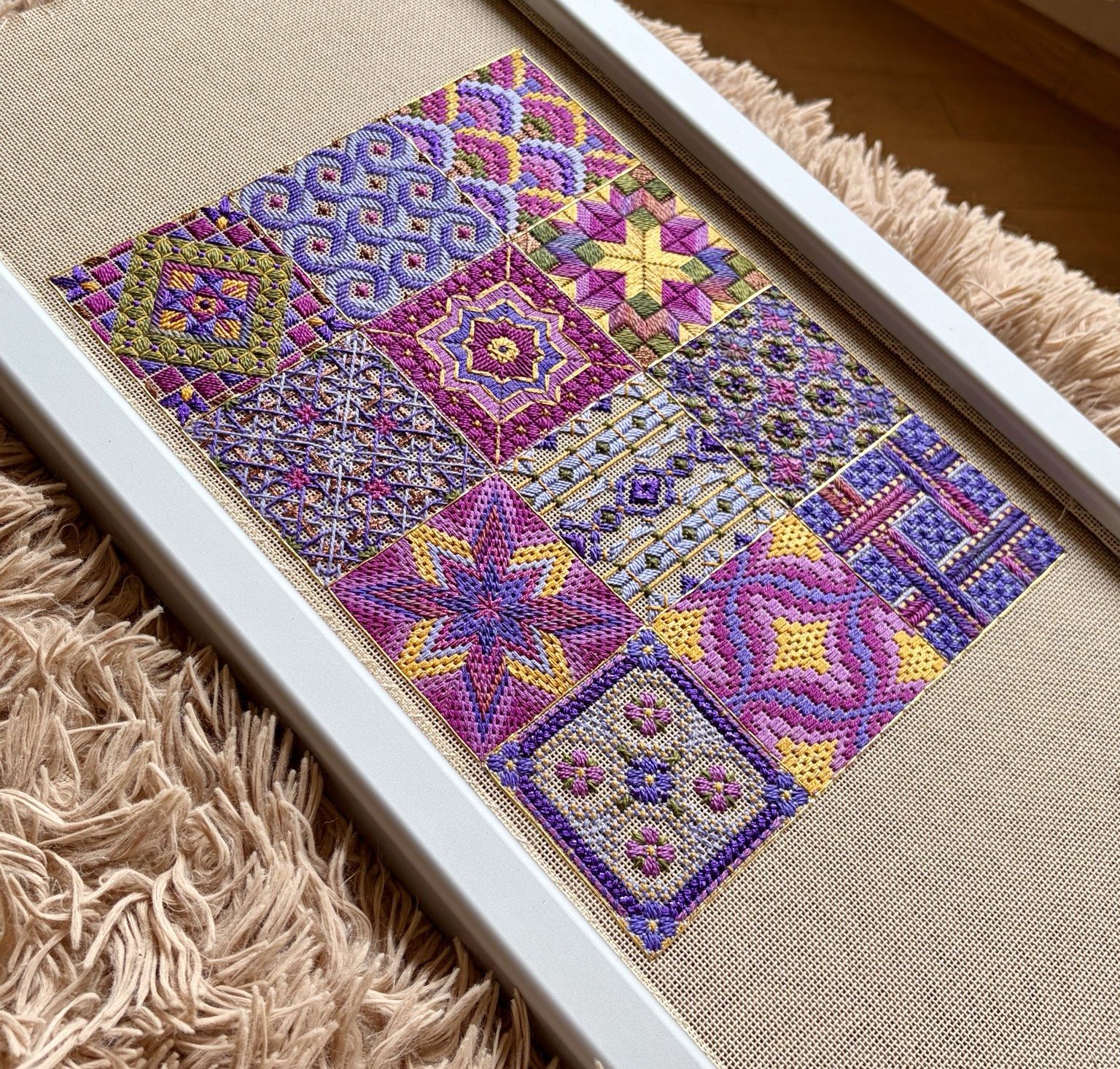 The completed twelve-tile The Bazaar Collection needlepoint shown unframed on canvas.